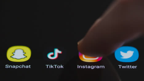 Close-Up-Shot-of-Finger-Tapping-Instagram-On-a-Smartphone-Screen