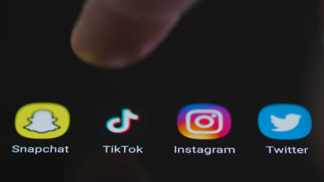 Close-Up-Shot-of-Finger-Tapping-TikTok-On-Smartphone-Screen