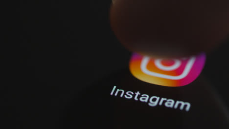 Close-Up-Shot-of-a-Finger-Tapping-Instagram-App-On-a-Smartphone-Screen