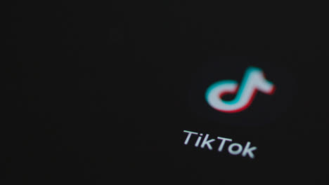 Close-Up-Shot-of-a-Finger-Tapping-TikTok-App-On-Smartphone-Screen