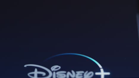 Close-Up-Shot-of-Finger-Tapping-Disney-Plus-On-Smartphone-Screen