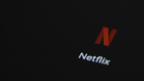 Close-Up-Shot-of-a-Finger-Tapping-Netflix-On-a-Smartphone-Screen