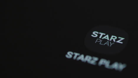 Close-Up-Shot-of-a-Finger-Tapping-Starz-Play-On-Smartphone-Screen