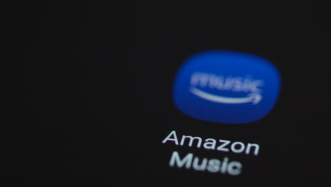 Close-Up-Shot-of-a-Finger-Tapping-Amazon-Music-On-Smartphone-Screen
