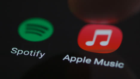 Close-Up-Shot-of-Finger-Tapping-Apple-Music-On-Smartphone-Screen