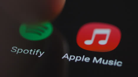 Close-Up-Shot-of-Finger-Tapping-Spotify-On-Smartphone-Screen