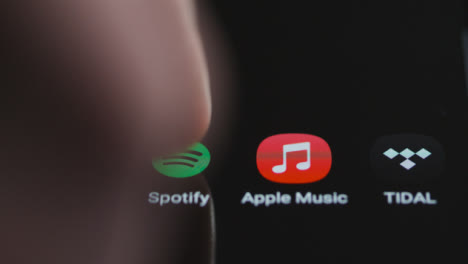 Close-Up-Shot-of-Finger-Tapping-Spotify-Music-On-a-Smartphone-Touch-Screen
