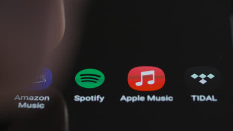Close-Up-Shot-of-Finger-Tapping-Spotify-Music-On-a-Smartphone-Touch-Screen