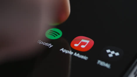 Close-Up-Shot-of-a-Finger-Tapping-Spotify-Music-On-a-Smartphone-Touch-Screen