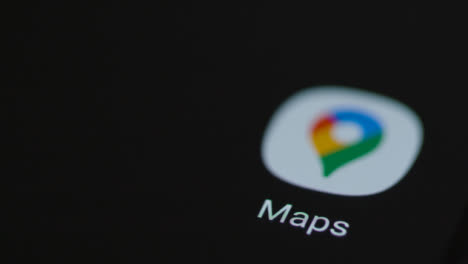 Close-Up-Shot-of-Finger-Tapping-the-Google-Maps-App-On-a-Smartphone