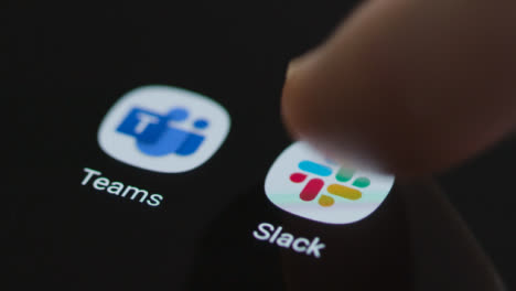 Close-Up-Shot-of-a-Finger-Tapping-the-Slack-App-On-Smartphone-Screen