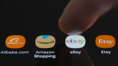 Close-Up-Shot-of-Finger-Tapping-the-Ebay-App-On-a-Smartphone
