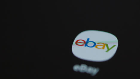 Close-Up-Shot-of-Finger-Tapping-the-Ebay-App-On-a-Smartphone-Screen