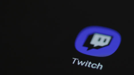 Close-Up-Shot-of-Finger-Tapping-the-Twitch-App-On-a-Smartphone-Screen