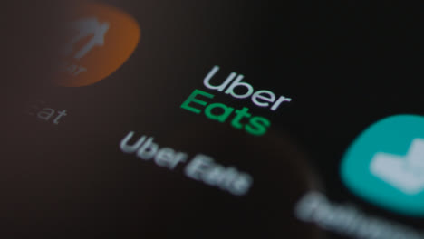 Close-Up-Shot-of-a-Finger-Tapping-the-Uber-Eats-App-On-a-Smartphone-