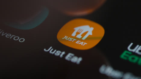 Close-Up-Shot-of-a-Finger-Tapping-the-Just-Eat-App-On-a-Smartphone-Screen