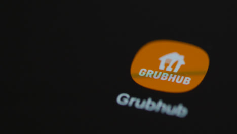 Close-Up-Shot-of-a-Finger-Tapping-the-Grubhub-App-On-Smartphone-Screen