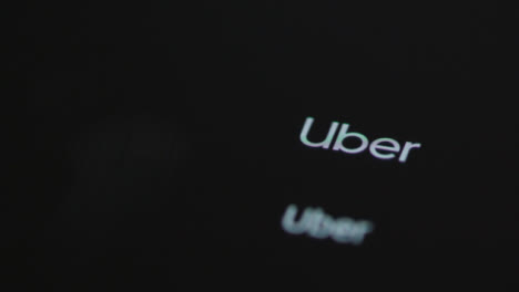 Close-Up-Shot-of-Finger-Tapping-the-Uber-App-On-a-Smartphone-Screen