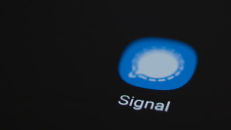 Close-Up-Shot-of-a-Finger-Tapping-the-Signal-App-On-Smartphone-Screen