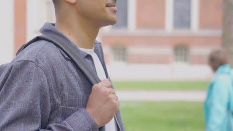 Close-Up-Shot-of-Young-Man-Throwing-a-Rucksack-Over-His-Shoulder