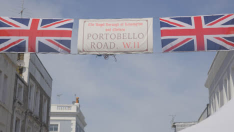 Tracking-Shot-of-Portobello-Flag-Sign-and-Union-Jacks