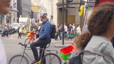Wide-Shot-of-Cyclist-In-Busy-London-Street