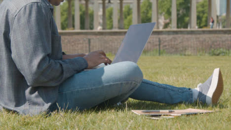 Handheld-Shot-of-a-Student-Working-In-Park