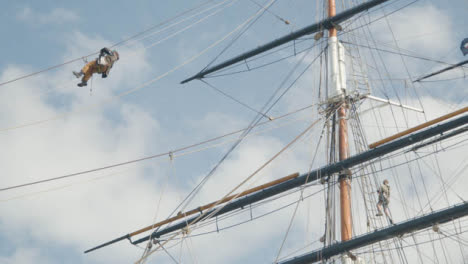 Low-Angle-Shot-of-Person-Maintaining-Old-Cutty-Sark-Ship