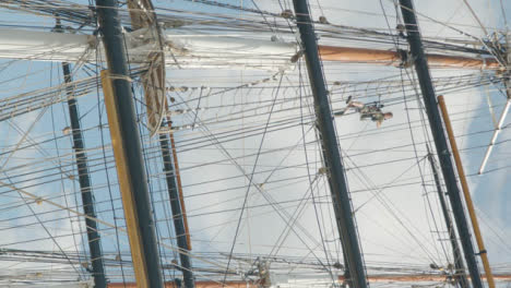 Vertical-Low-Angle-Shot-of-Person-Maintaining-Old-Cutty-Sark-Ship