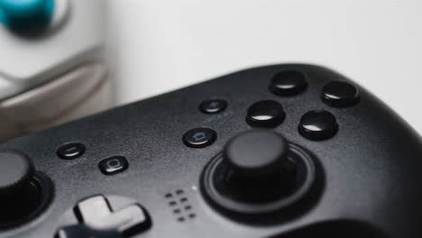 Studio-Close-Up-Of-Two-Video-Game-Controllers-On-White-Background-1