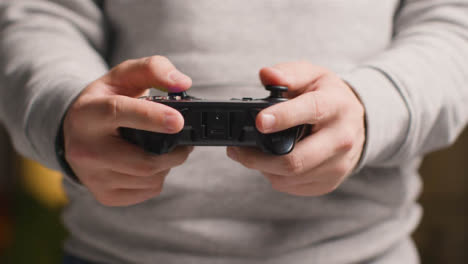 Front-On-Close-Up-Hands-As-Man-Plays-With-Video-Game-Controller-At-Home-8