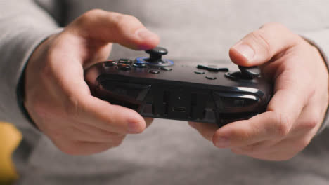 Front-On-Close-Up-Hands-As-Man-Plays-With-Video-Game-Controller-At-Home-9