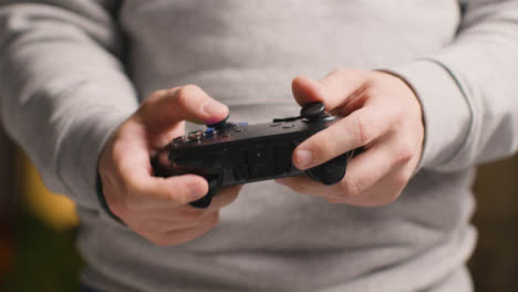 Front-On-Close-Up-Hands-As-Man-Plays-With-Video-Game-Controller-At-Home-10