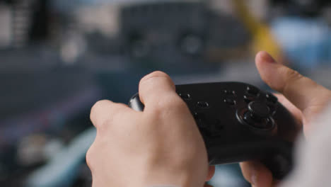 Close-Up-Hands-Man-Playing-Driving-Video-Game-Controller-Screen-Background-1