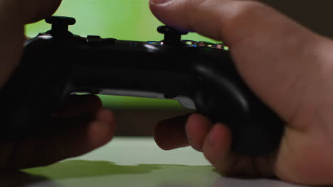 Close-Up-Hand-Picking-Up-Video-Game-Controller-Sports-Game-Screen-Background-1