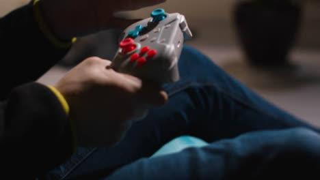Side-On-Close-Up-Hands-Frustrated-Man-Playing-Video-Game-Controller-Sitting-Sofa-At-Home