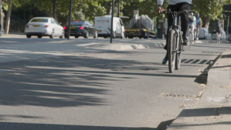 Close-Up-Of-Cyclists-In-Cycle-Lane-Commuting-To-Work-In-Busy-London-Street-1