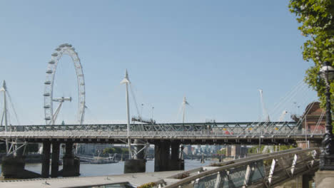 Commuters-Crossing-Hungerford-Charing-Cross-Bridge-In-London-With-London-Eye