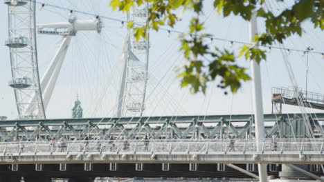 Commuters-Crossing-Hungerford-Charing-Cross-Bridge-London-Eye-In-Background