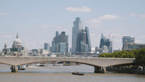 London-Bridge-With-Commuter-Traffic-And-London-City-Skyline-In-Background-UK