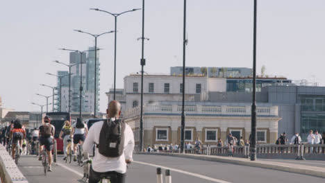 Pedestrians-Cyclists-Cars-Commuting-London-Bridge-Office-Buildings-Background