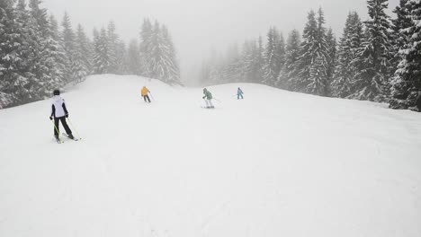 POV-Shot-Of-Skier-Skiing-Down-Misty-Snow-Covered-Mountain-With-Chair-Lift