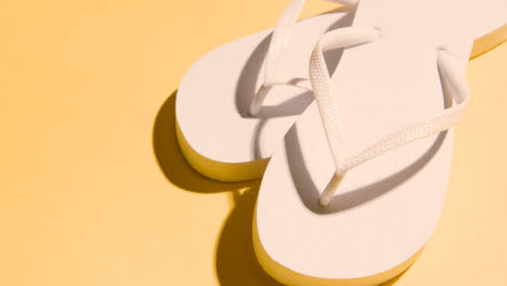 Summer-Holiday-Vacation-Concept-Of-Flip-Flops-Sandals-On-Yellow-Background-4
