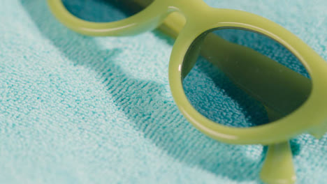 Summer-Holiday-Concept-Of-Hand-Picking-Up-Sunglasses-On-Beach-Towel-1