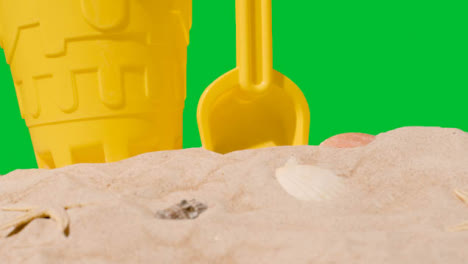 Summer-Holiday-Concept-With-Child's-Bucket-Spade-On-Sandy-Beach-Against-Green-Screen-2