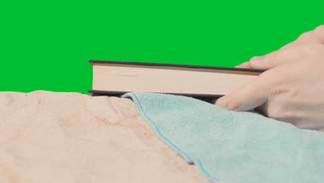 Summer-Holiday-Concept-Of-Person-On-Beach-Towel-Reading-Book-Against-Green-Screen-1