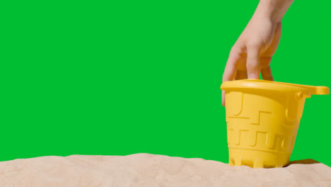 Summer-Holiday-Concept-With-Child's-Bucket-Spade-On-Sandy-Beach-Against-Green-Screen-3