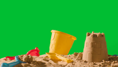 Summer-Holiday-Concept-Making-Sandcastle-On-Sandy-Beach-Against-Green-Screen-3