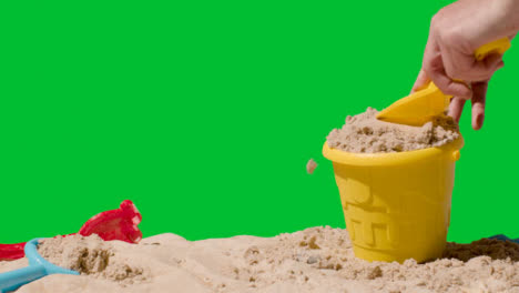 Summer-Holiday-Concept-Making-Sandcastle-On-Sandy-Beach-Against-Green-Screen-5