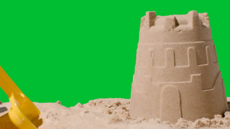 Summer-Holiday-Concept-Making-Sandcastle-On-Sandy-Beach-Against-Green-Screen-6